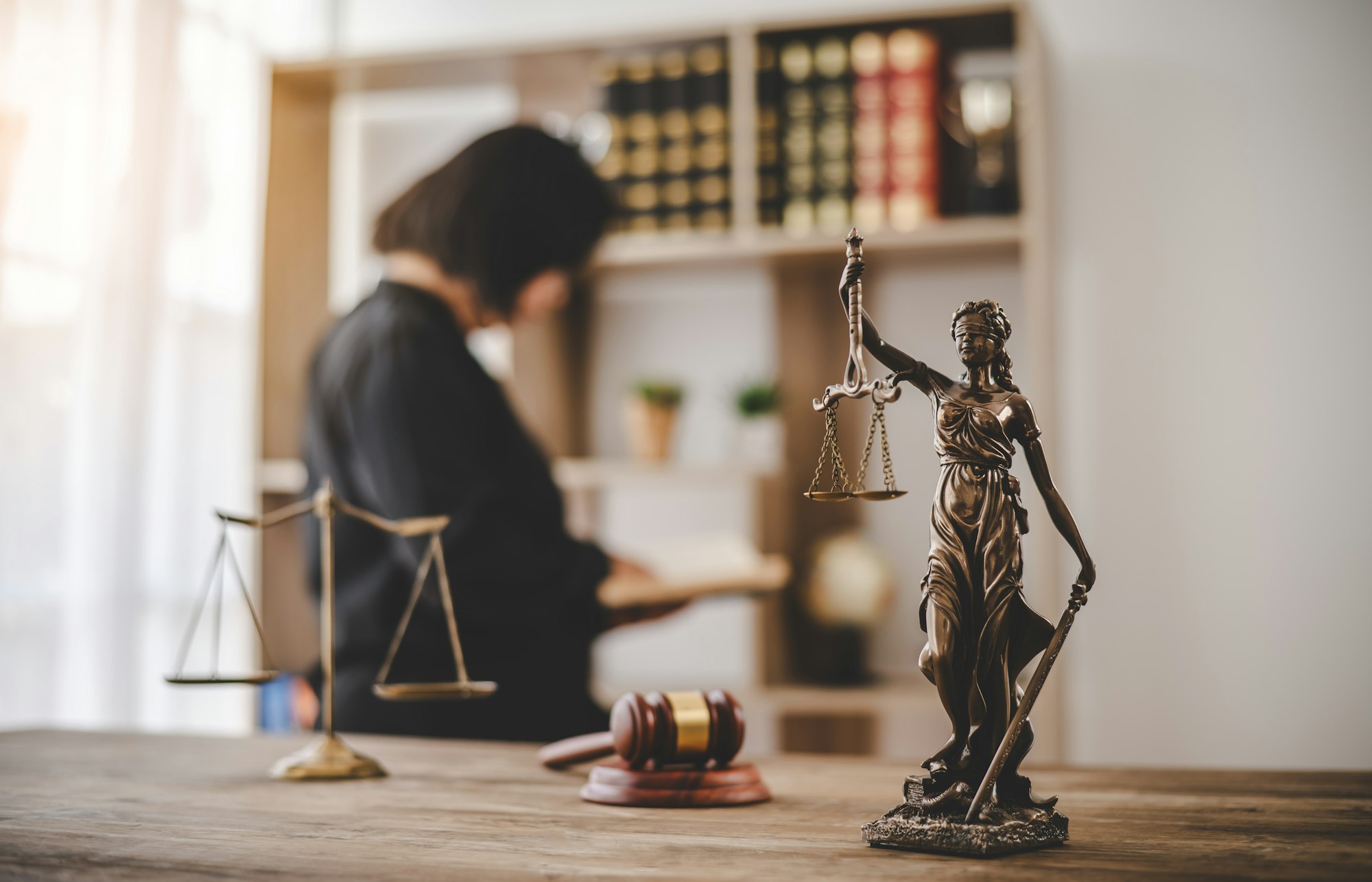 Lady Justice Holding Scales of Law in a Courtroom - Symbolizing Equality, Fairness